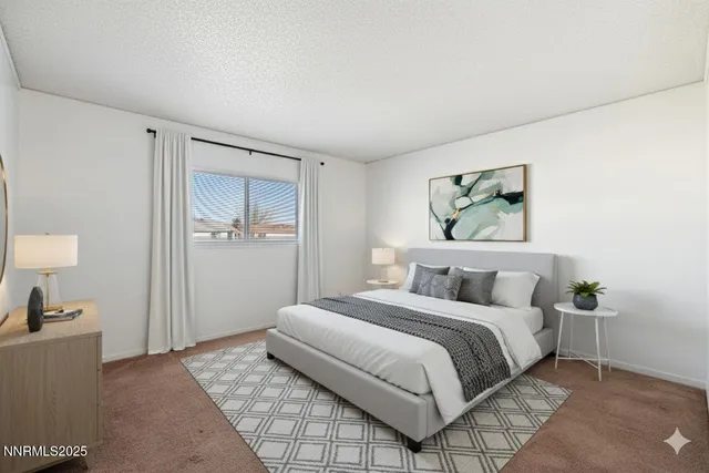 a bedroom with a bed and dresser with mirror