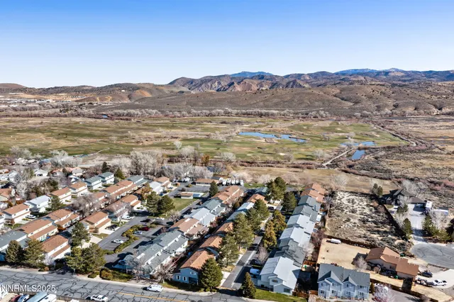 an aerial view of residential building and lake