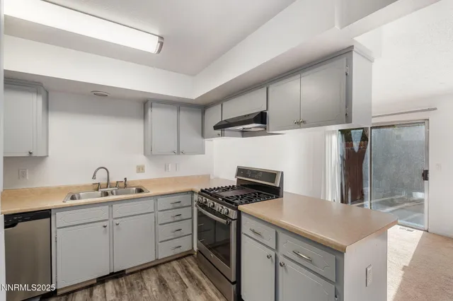a kitchen with a stove and a sink
