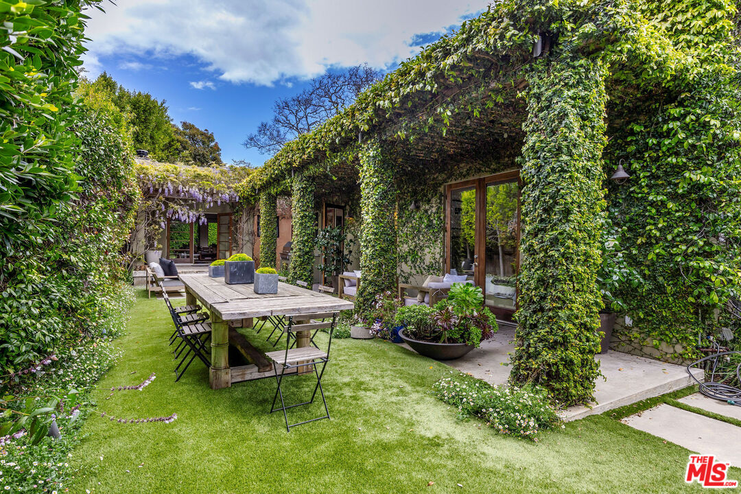 2211 Glencoe Avenue Venice, CA 90291 - Photo 17 of 19 a view of a backyard with table and chairs potted plants and large tree