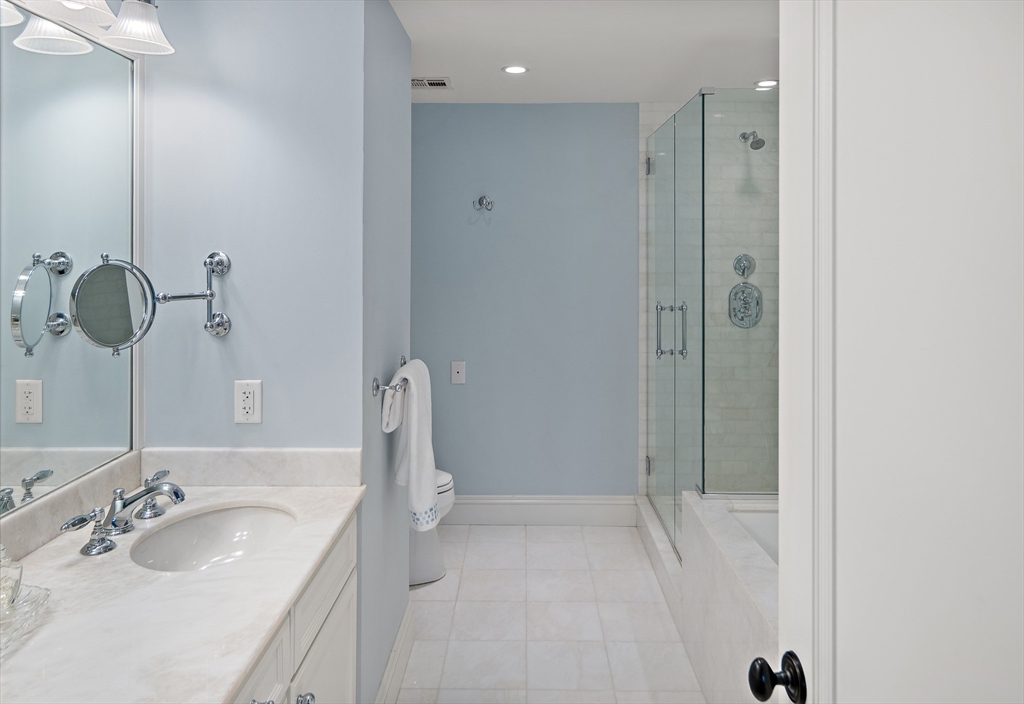 300 Boylston Street, Unit 909 Boston, MA 02116 - Photo 15 of 18 a bathroom with a sink and mirror