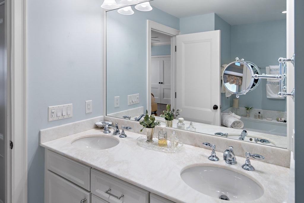 300 Boylston Street, Unit 909 Boston, MA 02116 - Photo 17 of 18 a bathroom with a sink and a mirror