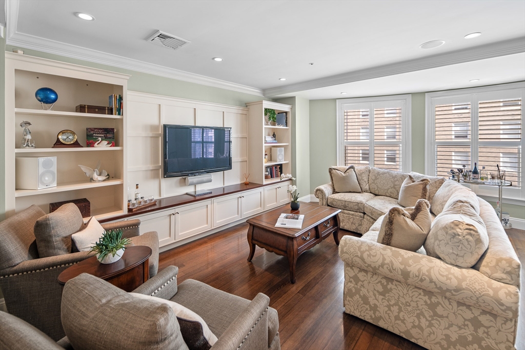 300 Boylston Street, Unit 909 Boston, MA 02116 - Photo 7 of 18 a living room with furniture and a flat screen tv