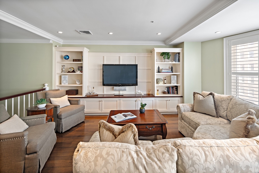 300 Boylston Street, Unit 909 Boston, MA 02116 - Photo 8 of 18 a living room with furniture and a flat screen tv