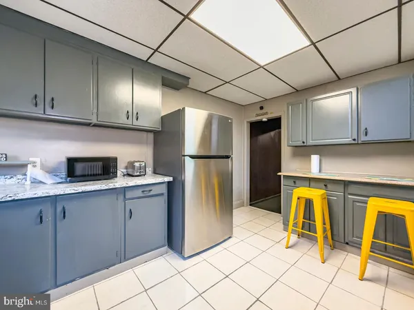 a kitchen with a refrigerator and a sink