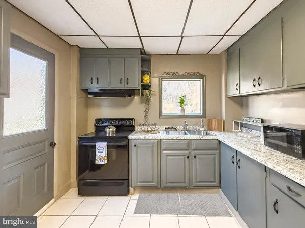 a kitchen with a sink stove and cabinets