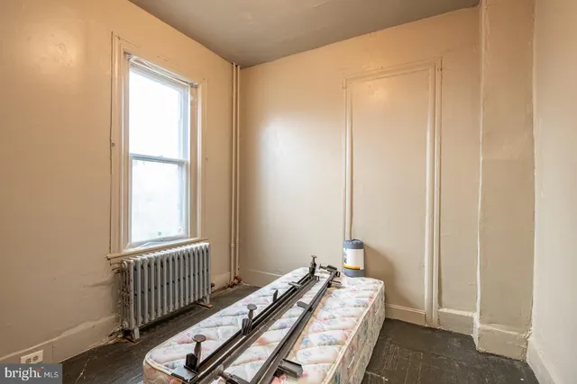 a bedroom with bed and a window