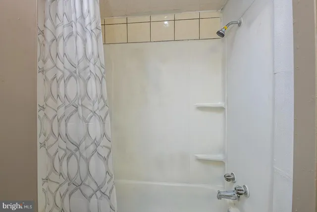 a bathroom with a bathtub and shower