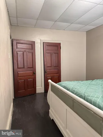 a room with a bed and a dresser