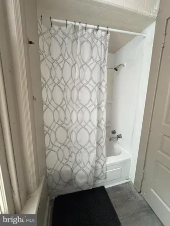 a bathroom with a bathtub and shower