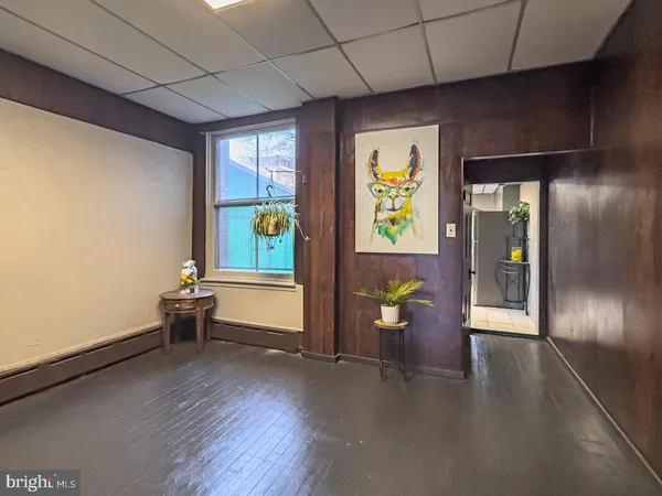 a view of an entryway with wooden floor and windows
