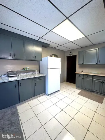 a kitchen with a cabinets and white appliances