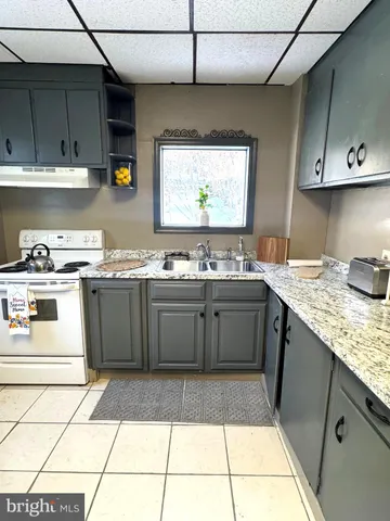 a kitchen with a sink appliances and cabinets