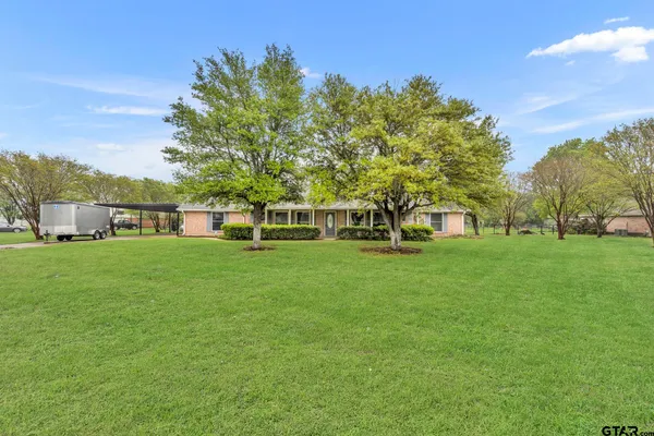 a view of house with garden space and trees