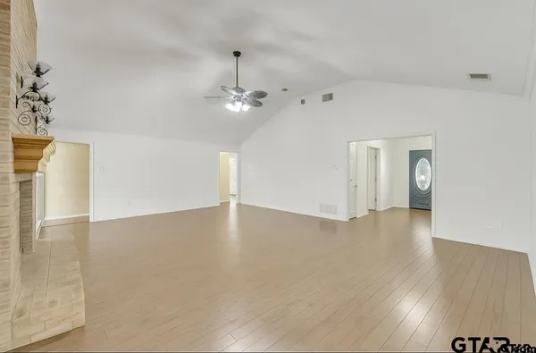 a kitchen with stainless steel appliances granite countertop a sink dishwasher stove and refrigerator with wooden floor