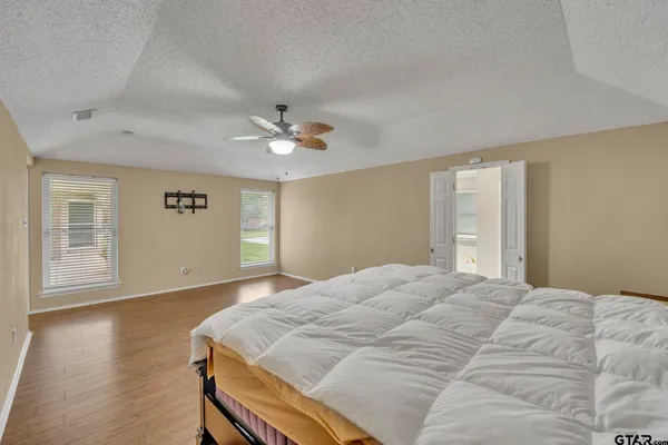 a bedroom with a bed and a chandelier