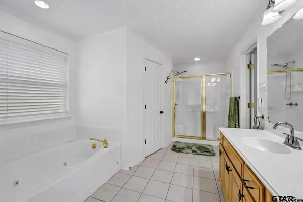 a bathroom with a tub sink and a mirror