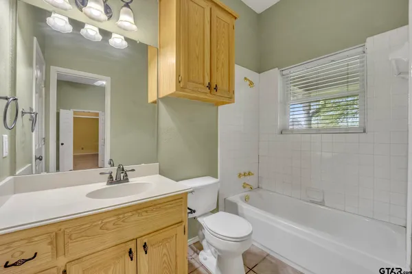 a bathroom with a sink a toilet and bathtub