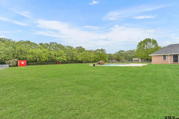 a green field with lots of tress in it