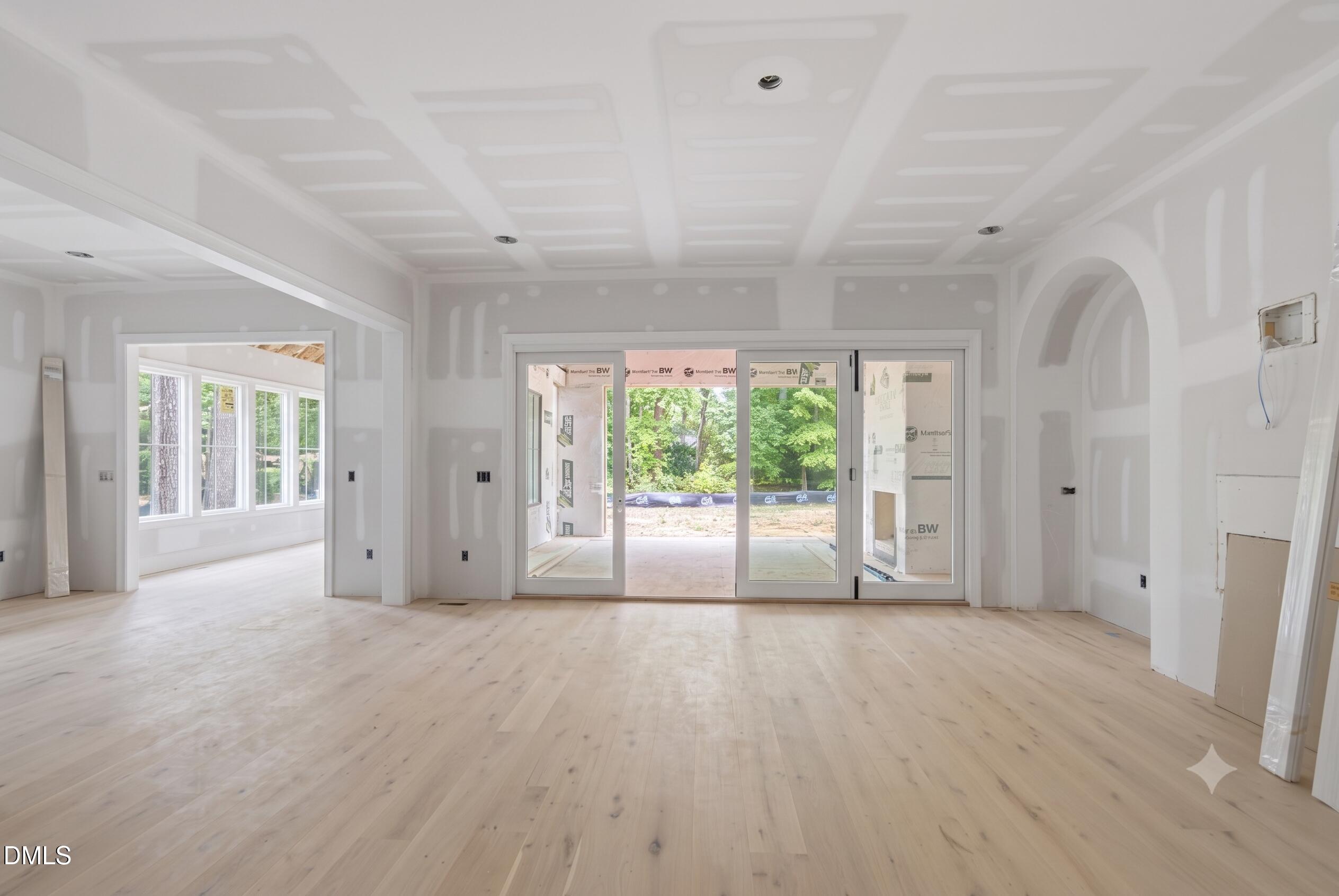 7508 Grist Mill Road Raleigh, NC 27615 - Photo 5 of 32 a view of an empty room with a window and wooden floor
