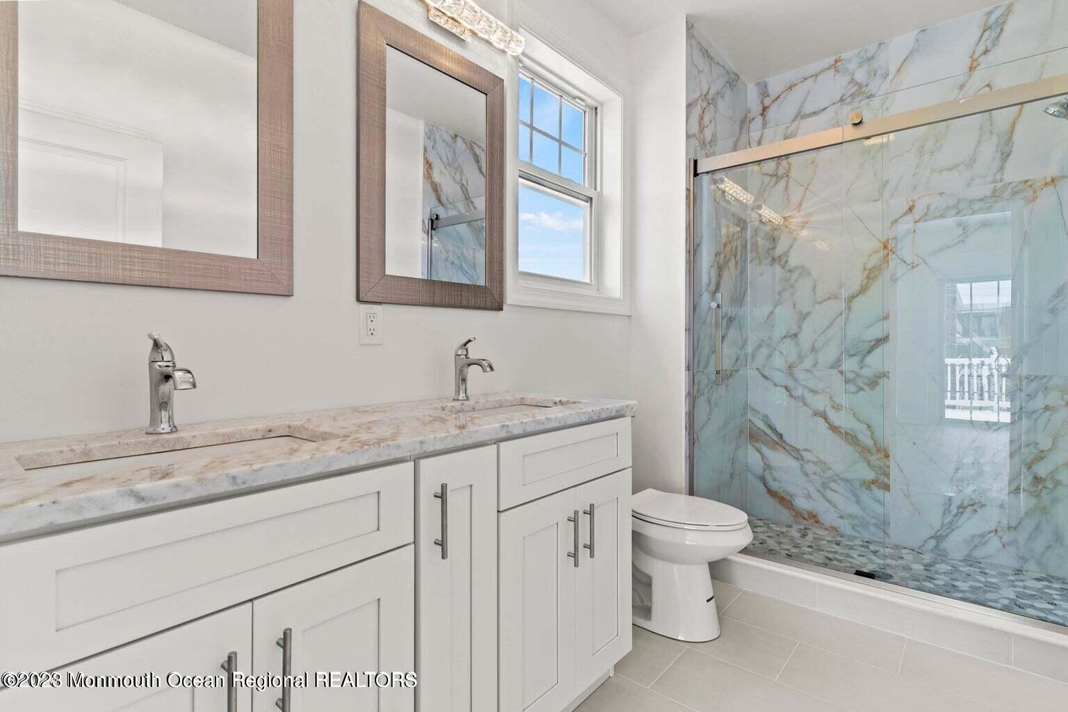 61 Hamilton Avenue Seaside Heights, NJ 08751 - Photo 11 of 31 a bathroom with a granite countertop sink a toilet and a mirror