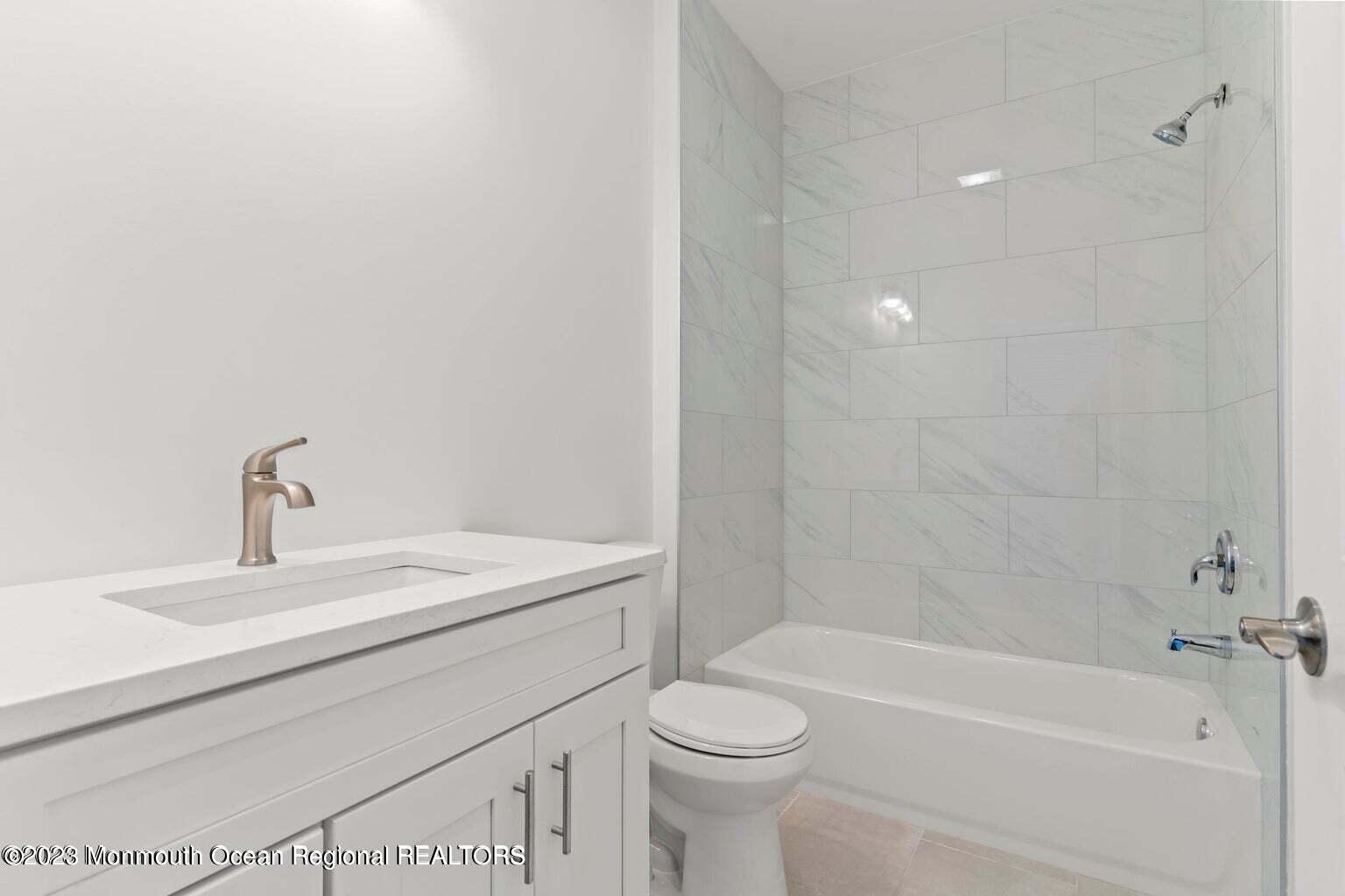 61 Hamilton Avenue Seaside Heights, NJ 08751 - Photo 16 of 31 a bathroom with a sink a toilet and a bathtub