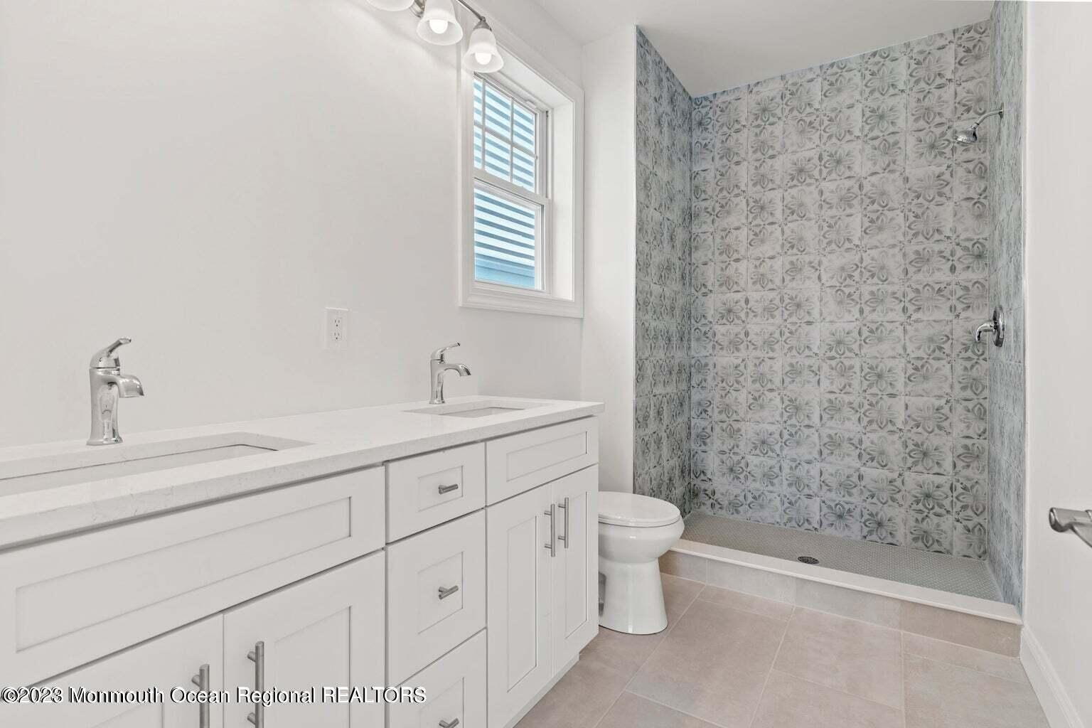 61 Hamilton Avenue Seaside Heights, NJ 08751 - Photo 26 of 31 a bathroom with a granite countertop sink a toilet and shower