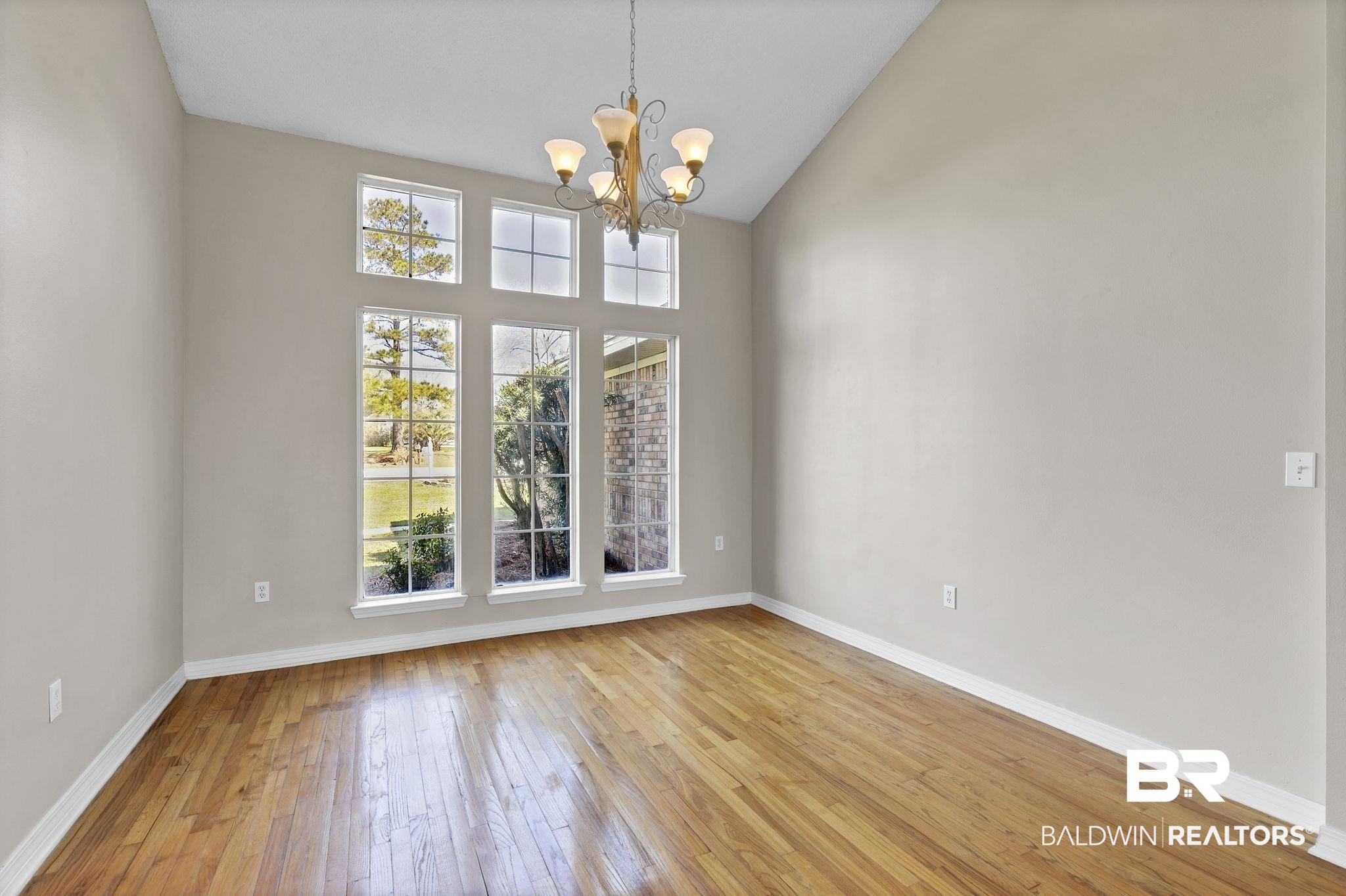 10238 Grove Drive Fairhope, AL 36532 - Photo 8 of 39 Dining area with a chandelier, plenty of natural light, and light hard wood floors