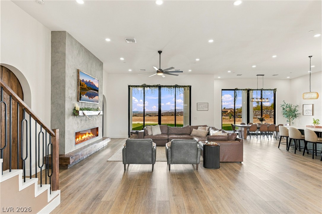 324 Wanda Road Henderson, NV 89002 - Photo 9 of 96 A modern linear fireplace anchors the airy, open-concept living space with wide-plank wood flooring.