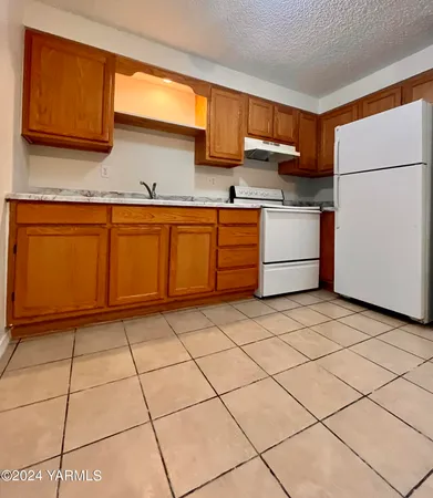 a kitchen with a cabinets and white appliances