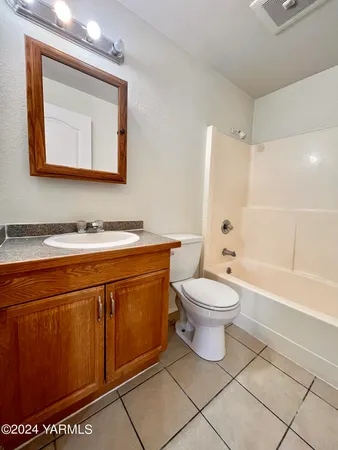 a bathroom with a toilet a sink and bathtub