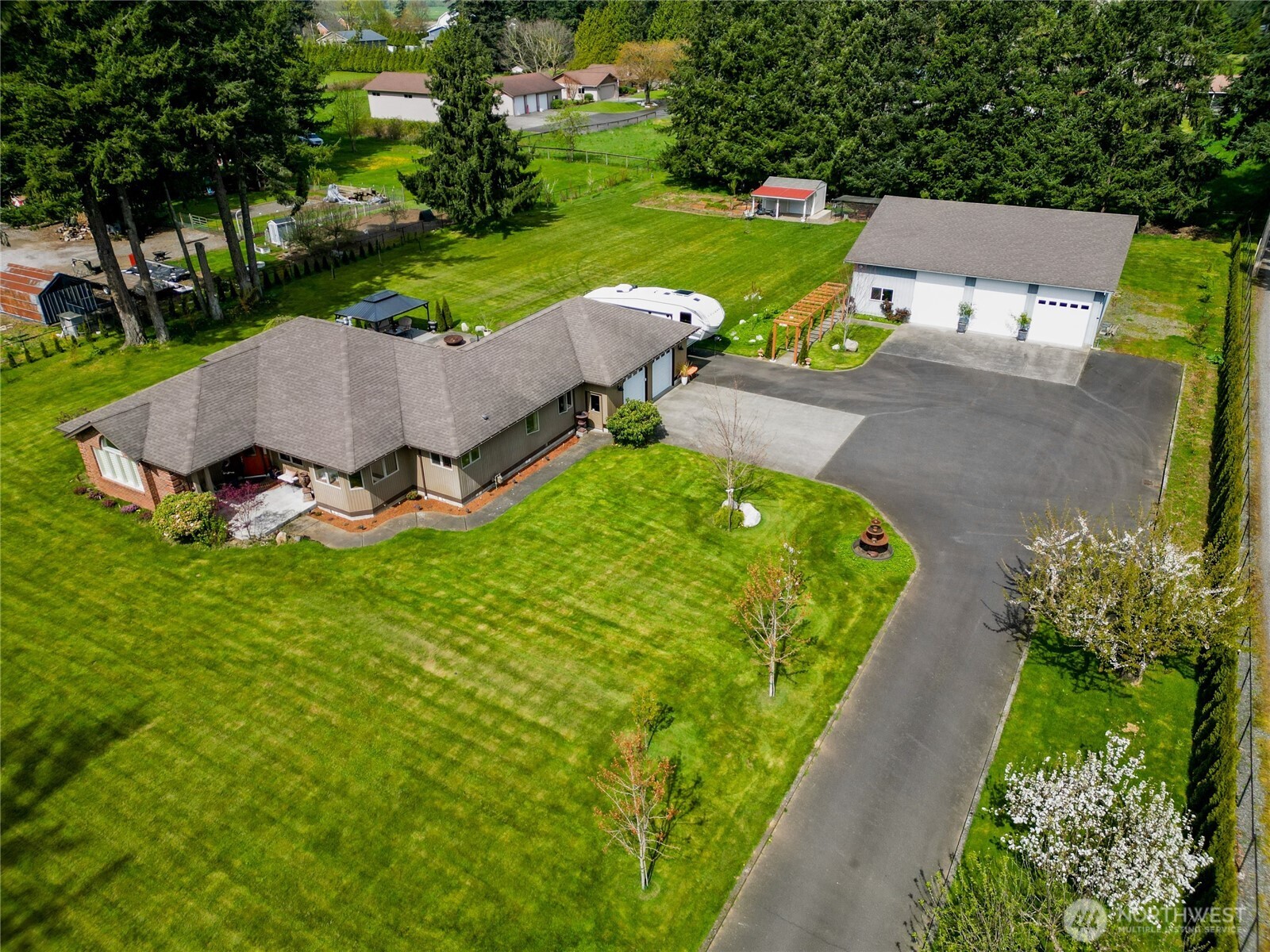 an aerial view of a house with garden space and street view