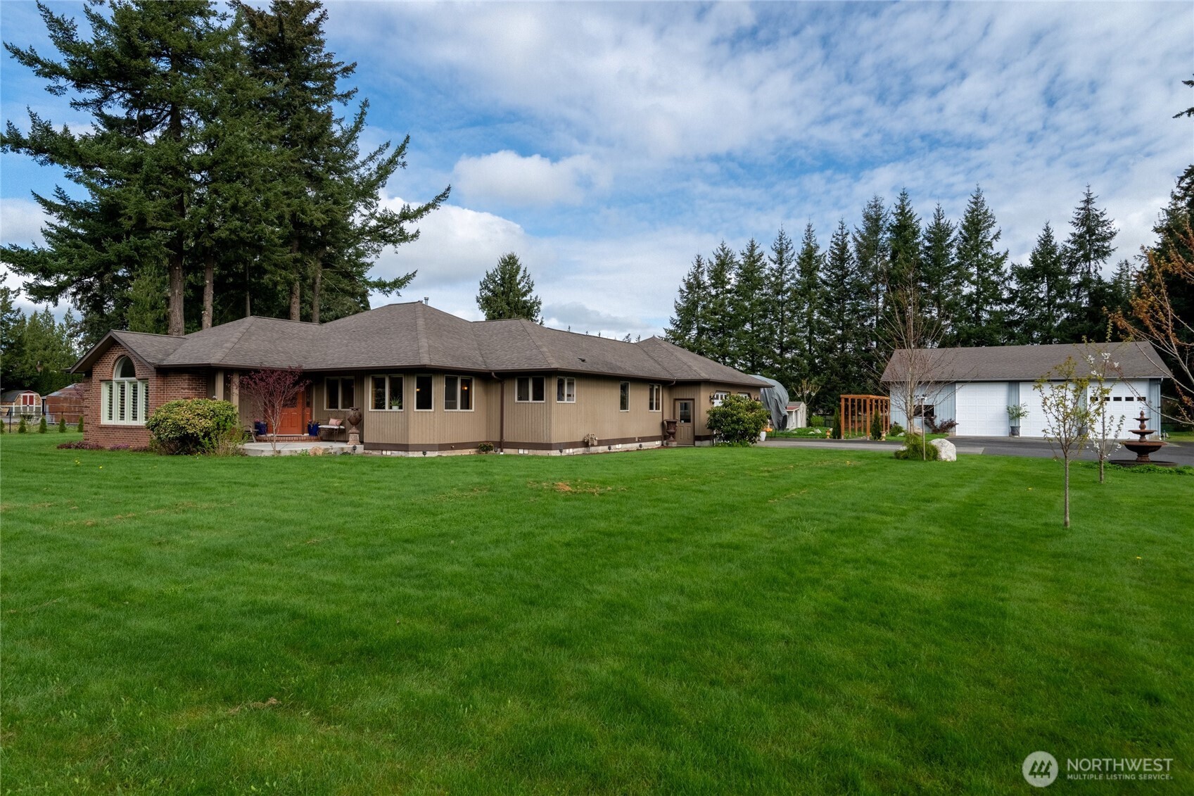 770 East Wiser Lake Road Lynden, WA 98264 - Photo 2 of 36 a view of a big house with a big yard and large trees