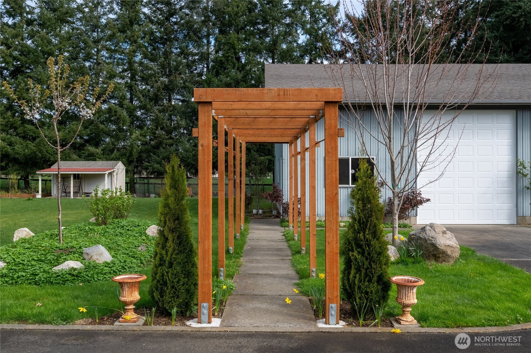 770 East Wiser Lake Road Lynden, WA 98264 - Photo 28 of 36 a view of a house with brick walls and flower plants