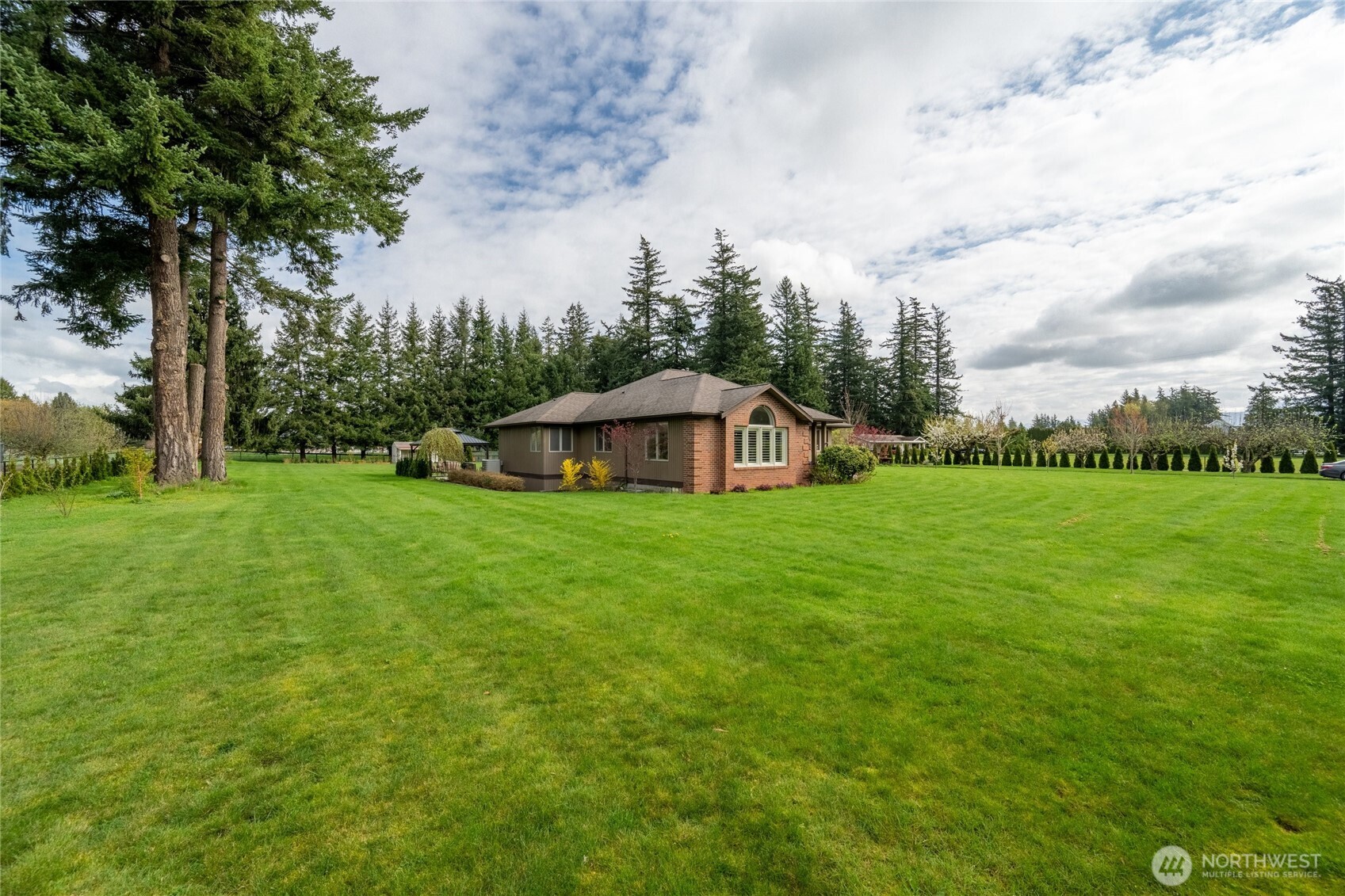 770 East Wiser Lake Road Lynden, WA 98264 - Photo 32 of 36 a view of a house with a yard and sitting area