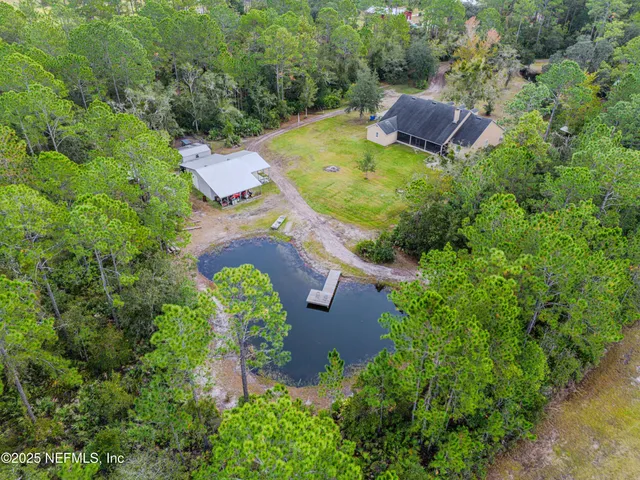 a kitchen with stainless steel appliances kitchen island granite countertop a dining table chairs and granite counter tops
