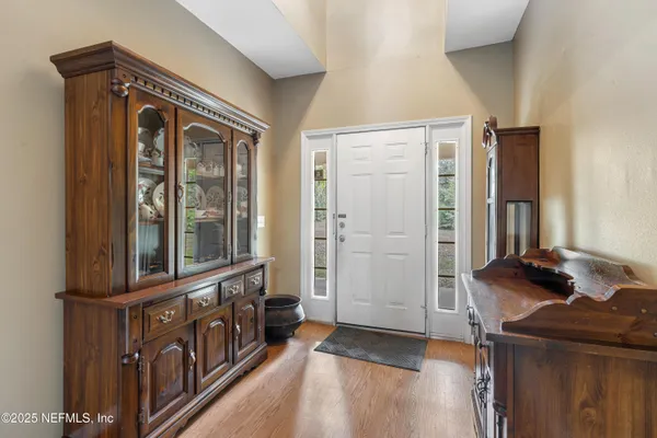 a view of a dining room with furniture and wooden floor