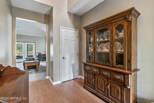 a view of a dining room with furniture wooden floor and chandelier