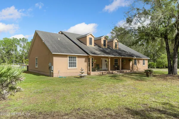 a front view of a house with a garden