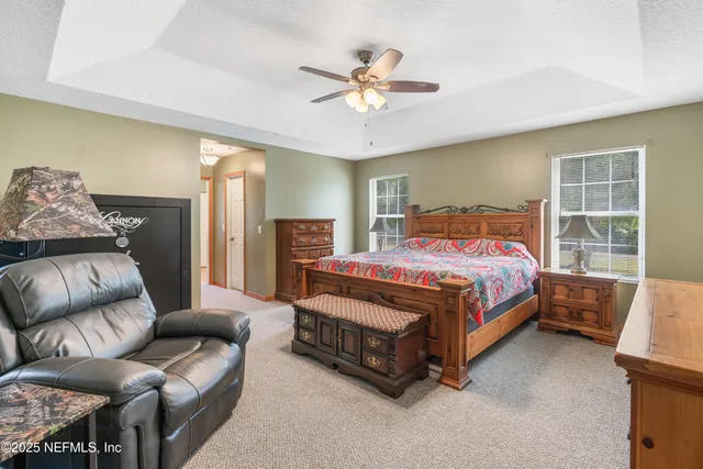 a bed sitting in a bedroom next to a window