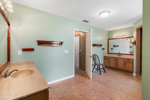 a aerial view of a house with a yard and large tree