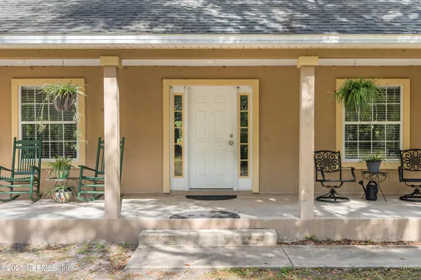 a view of front door with chair and table