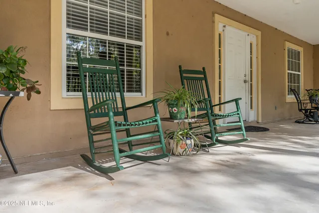 a view of a yard with wooden fence