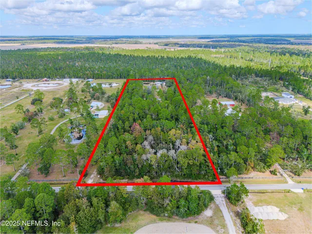 an aerial view of a house with outdoor space pool seating area and yard
