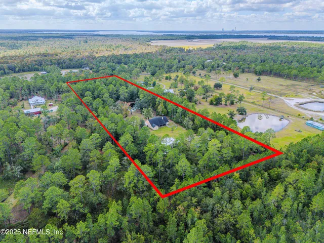 a view of a livingroom with wooden floor and furniture