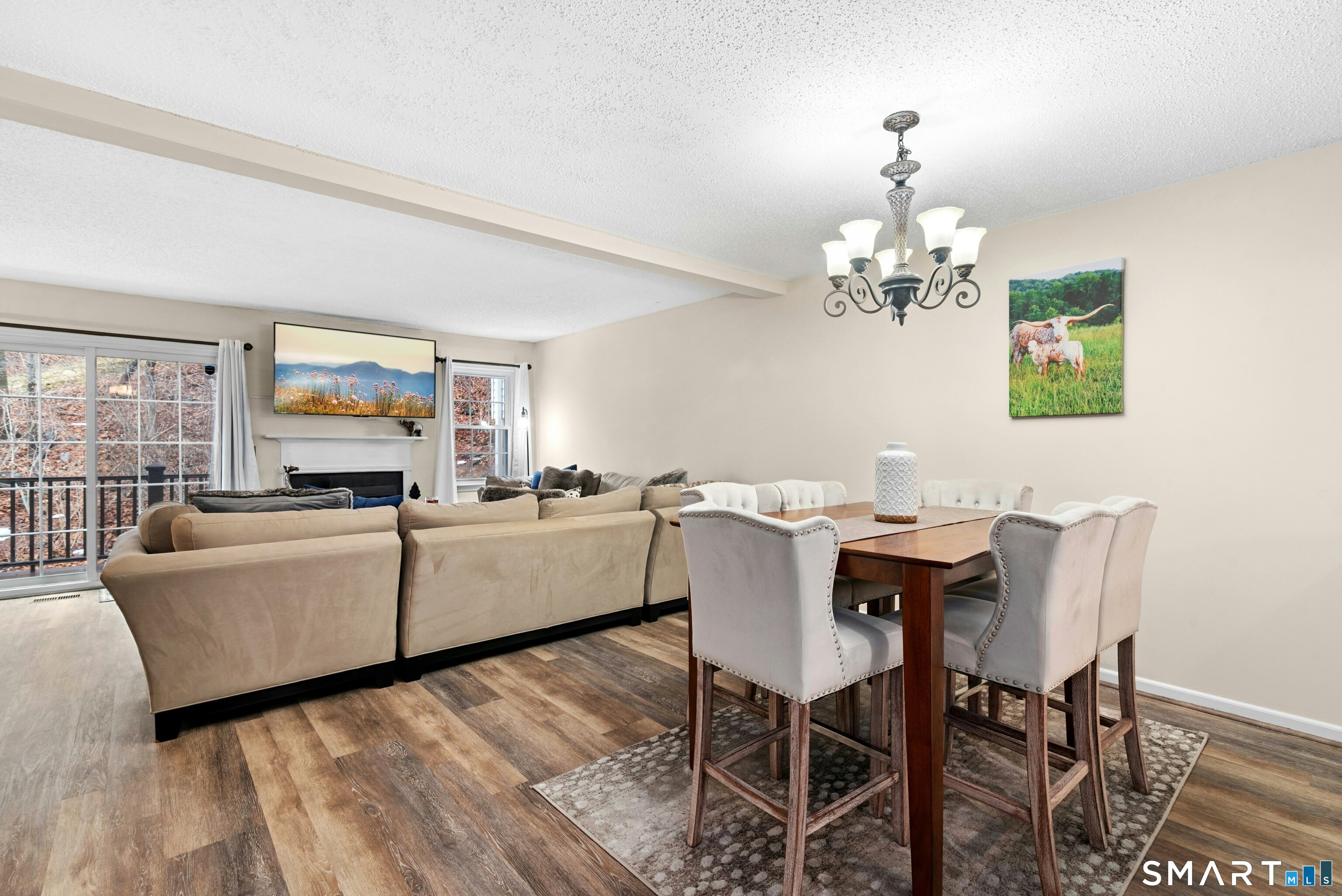 55 Mill Plain Road, Unit 193 Danbury, CT 06811 - Photo 1 of 27 a living room with furniture and a chandelier