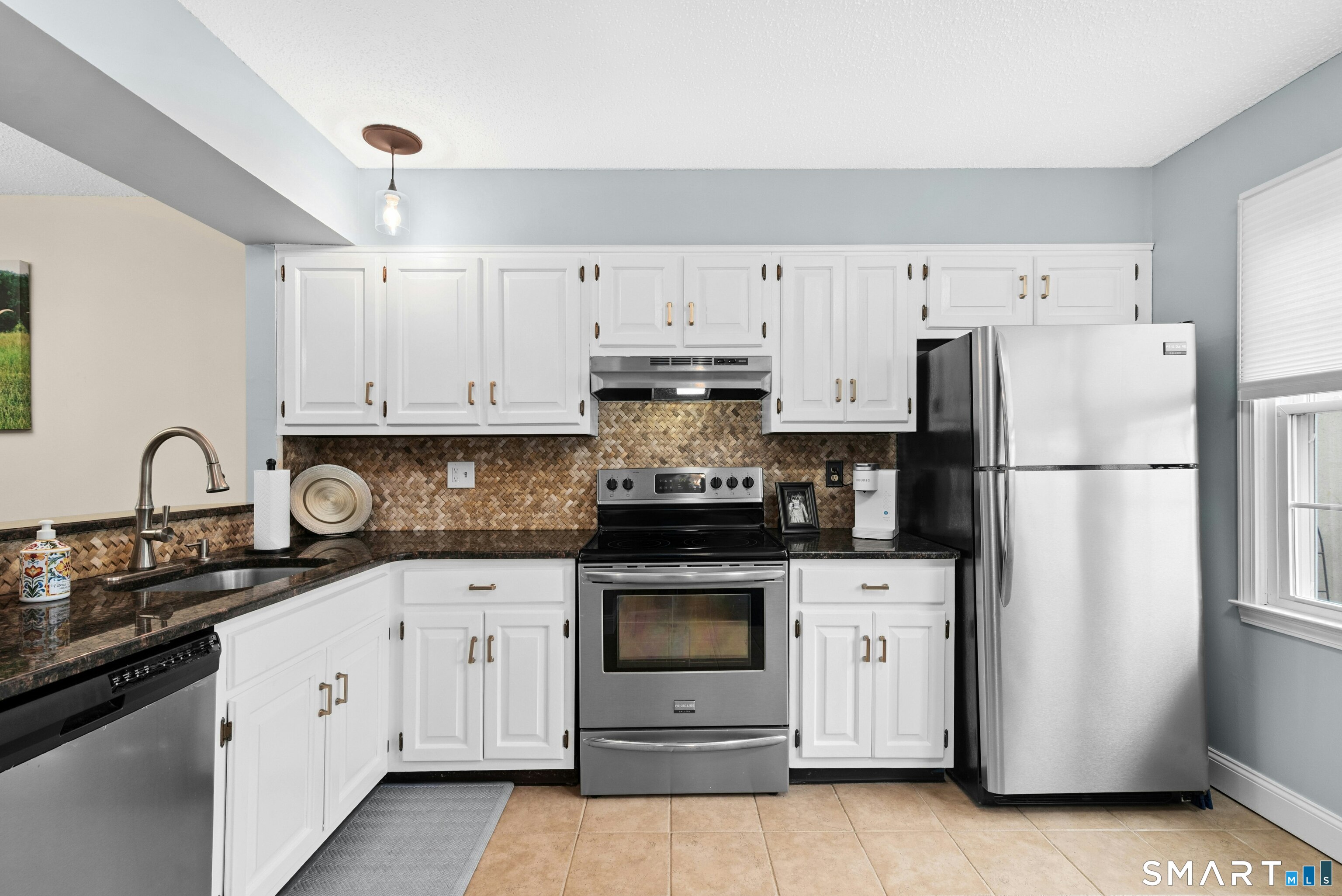 55 Mill Plain Road, Unit 193 Danbury, CT 06811 - Photo 11 of 27 a kitchen with white cabinets and white appliances