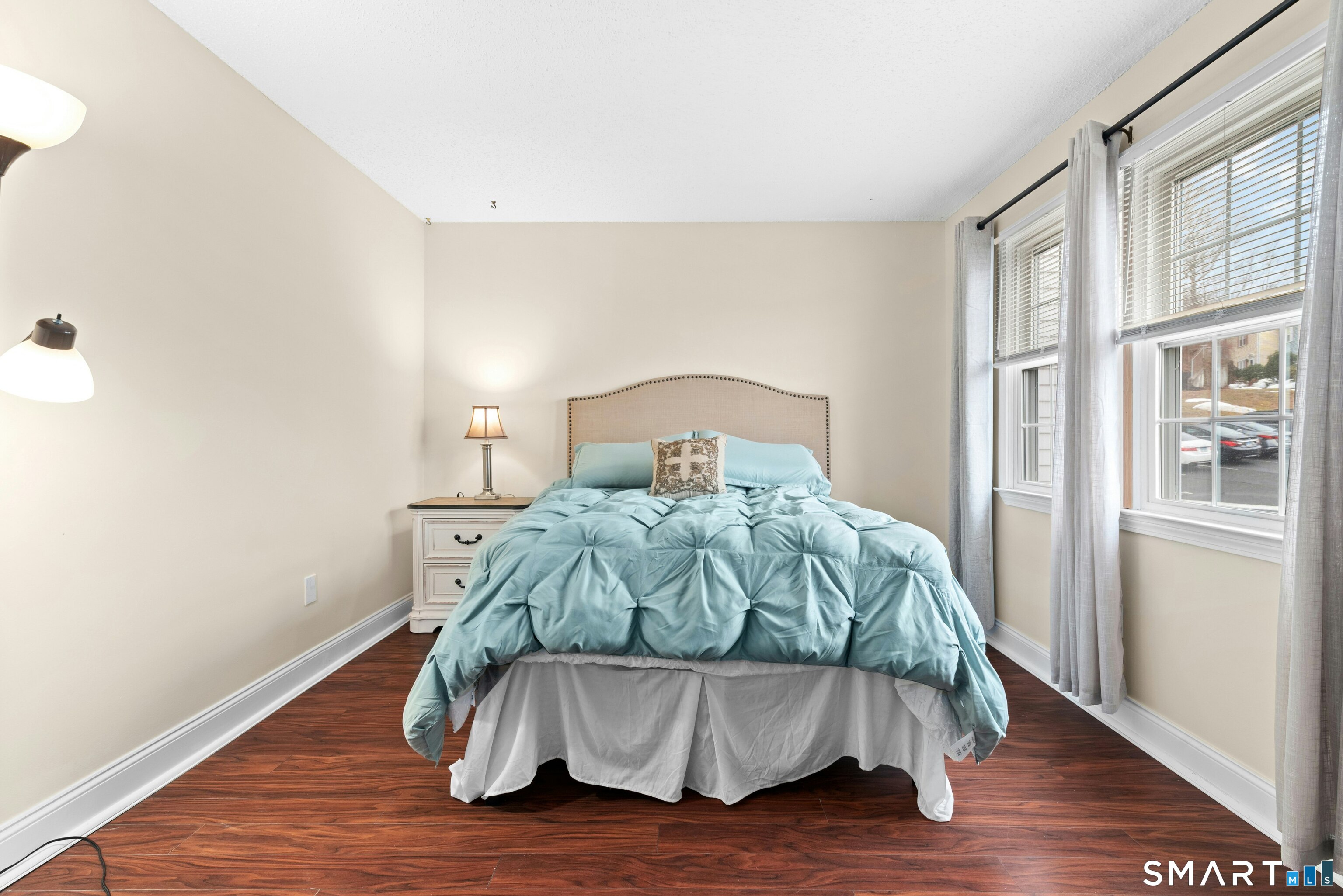 55 Mill Plain Road, Unit 193 Danbury, CT 06811 - Photo 17 of 27 a bedroom with a bed and wooden floor