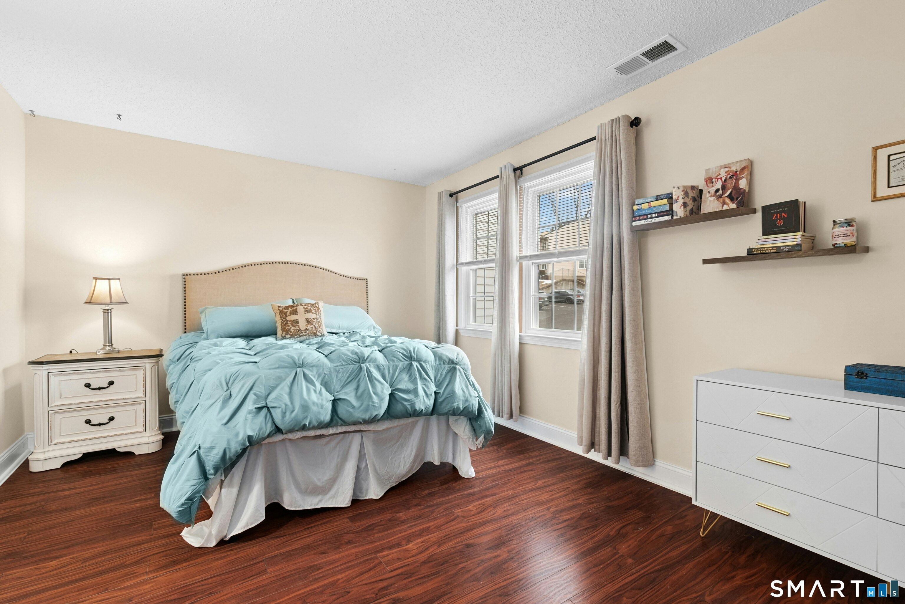 55 Mill Plain Road, Unit 193 Danbury, CT 06811 - Photo 18 of 27 a bedroom with a bed and wooden floor