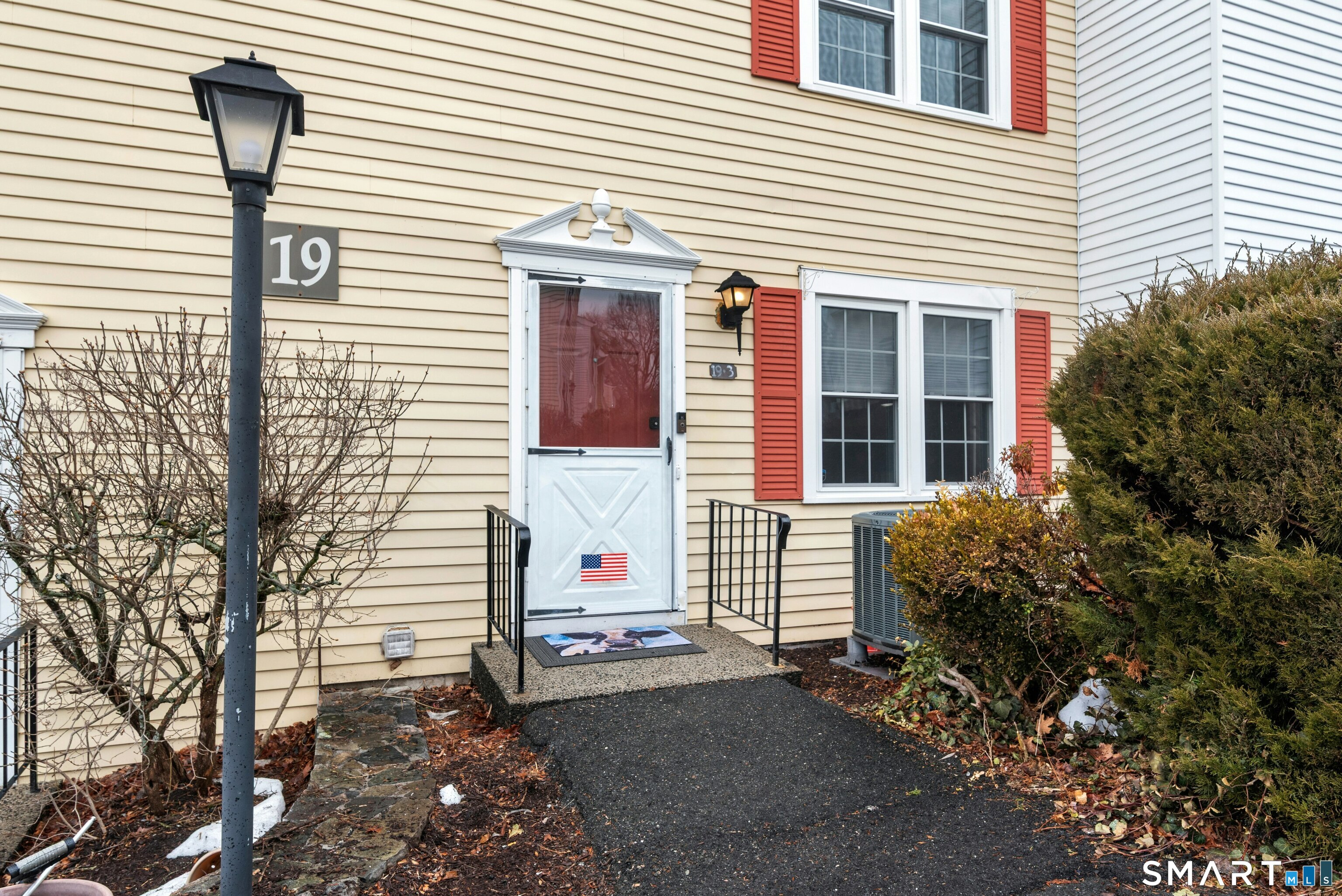 55 Mill Plain Road, Unit 193 Danbury, CT 06811 - Photo 2 of 27 a front view of a house with a yard and garage